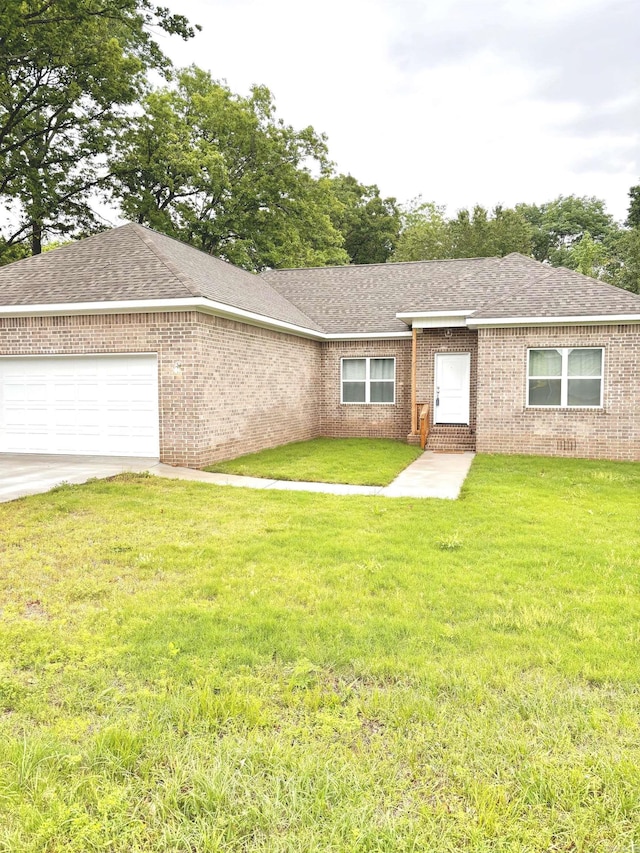 single story home featuring a garage and a front yard