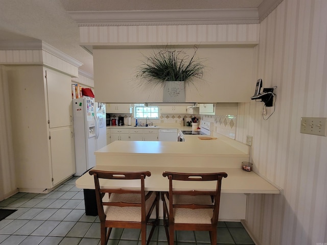 kitchen with crown molding, white appliances, white cabinetry, kitchen peninsula, and light tile patterned flooring