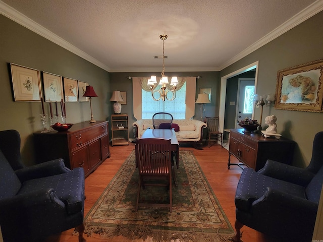 dining space with a textured ceiling, a chandelier, and hardwood / wood-style floors