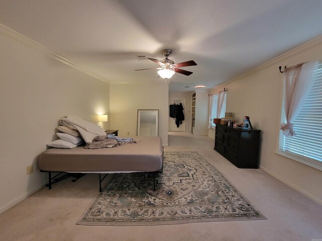 carpeted bedroom featuring ceiling fan and ornamental molding