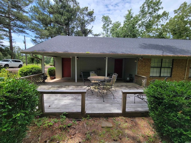 rear view of property featuring a deck