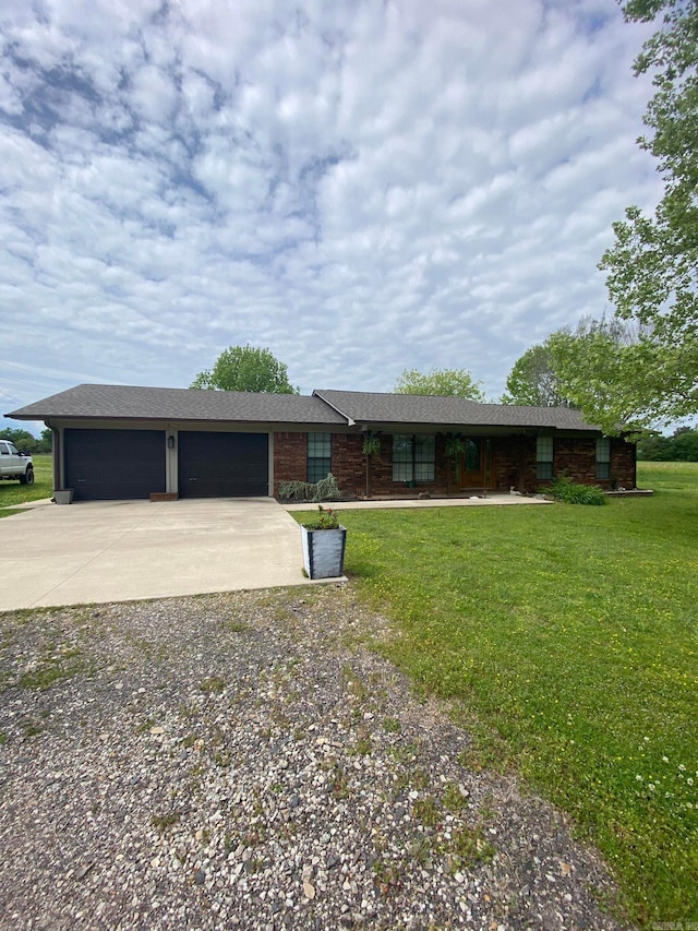 ranch-style home featuring a garage and a front yard