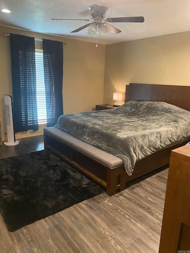 bedroom with ceiling fan and hardwood / wood-style flooring