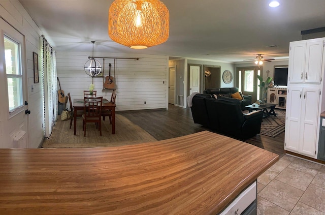 tiled dining area with ceiling fan