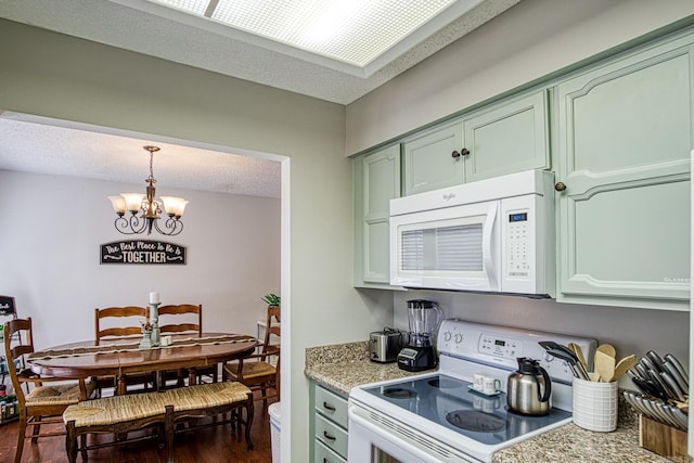 kitchen with decorative light fixtures, white appliances, dark hardwood / wood-style flooring, a chandelier, and a textured ceiling