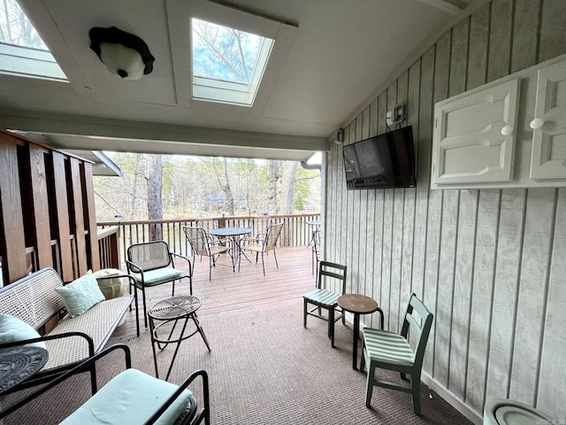 exterior space with vaulted ceiling with skylight