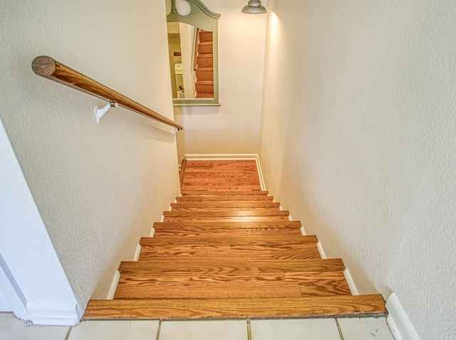 staircase featuring tile floors