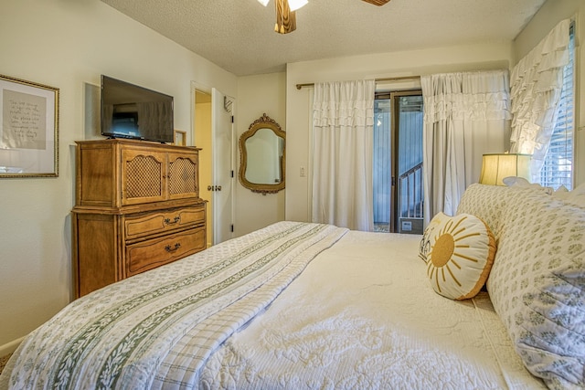 bedroom featuring a textured ceiling, ceiling fan, and access to exterior