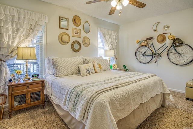 bedroom featuring ceiling fan, carpet, and a textured ceiling