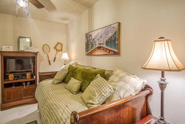 bedroom featuring a textured ceiling, ceiling fan, and tile flooring