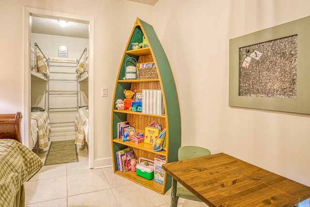 rec room with a textured ceiling and tile flooring