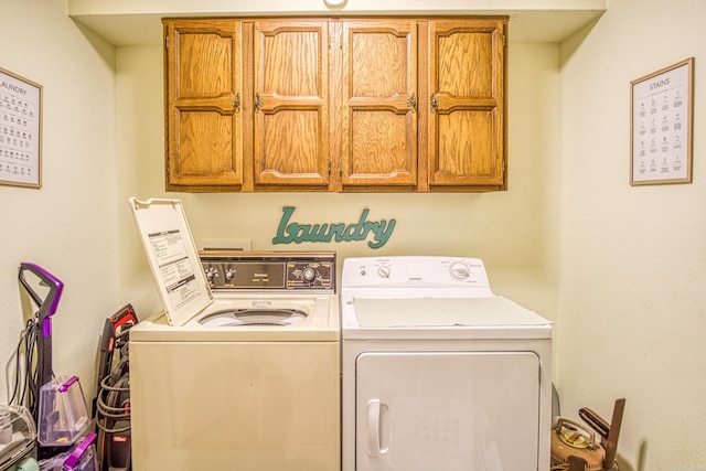 laundry area with cabinets, washer hookup, and washer and clothes dryer