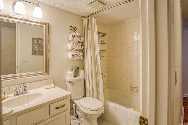 full bathroom with shower / bath combo with shower curtain, vanity, tile flooring, toilet, and a textured ceiling