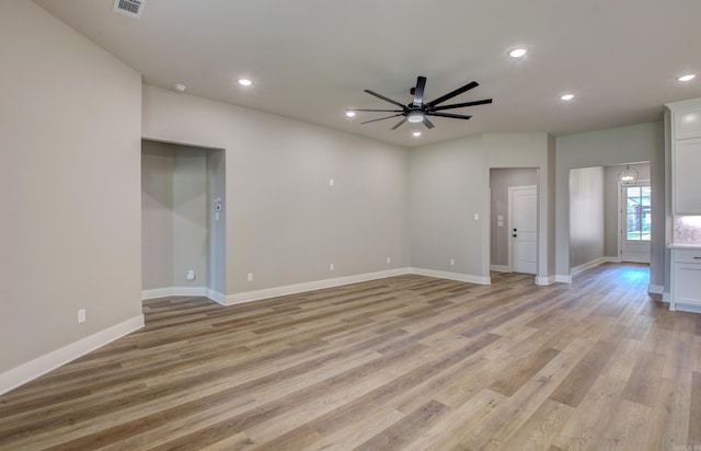 empty room with light wood-type flooring and ceiling fan