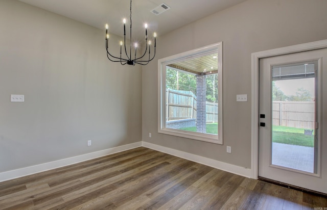 interior space featuring wood-type flooring and an inviting chandelier