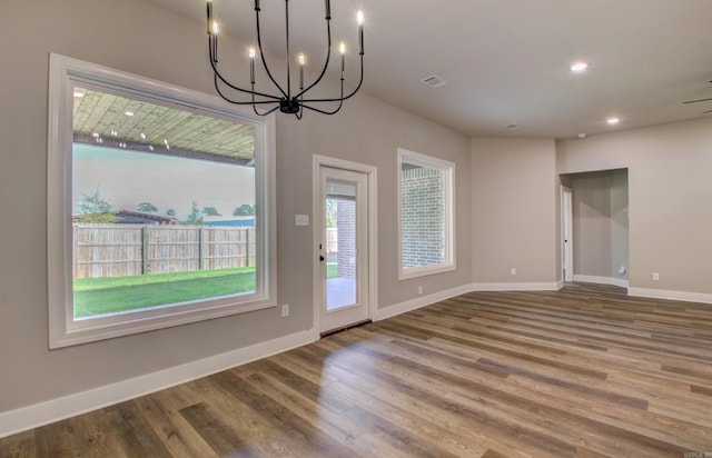 interior space with hardwood / wood-style floors and a notable chandelier