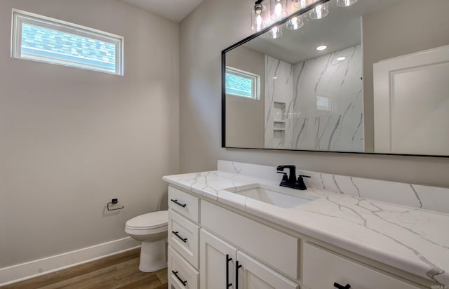 bathroom with vanity, toilet, wood-type flooring, and a shower