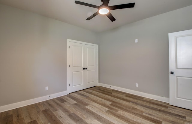 empty room featuring ceiling fan and light wood-type flooring