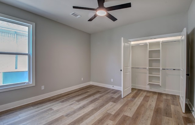 unfurnished bedroom featuring ceiling fan, a closet, and light hardwood / wood-style floors