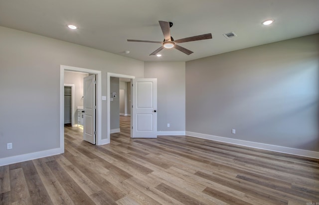 unfurnished bedroom featuring light wood-type flooring and ceiling fan