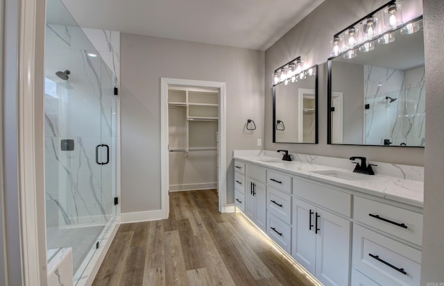 bathroom featuring vanity, hardwood / wood-style floors, and an enclosed shower