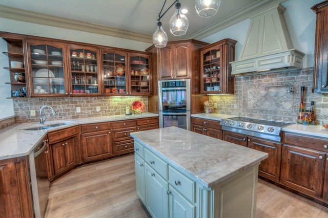 kitchen featuring backsplash, custom exhaust hood, and sink