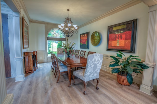 dining room with wood-type flooring, an inviting chandelier, and ornamental molding