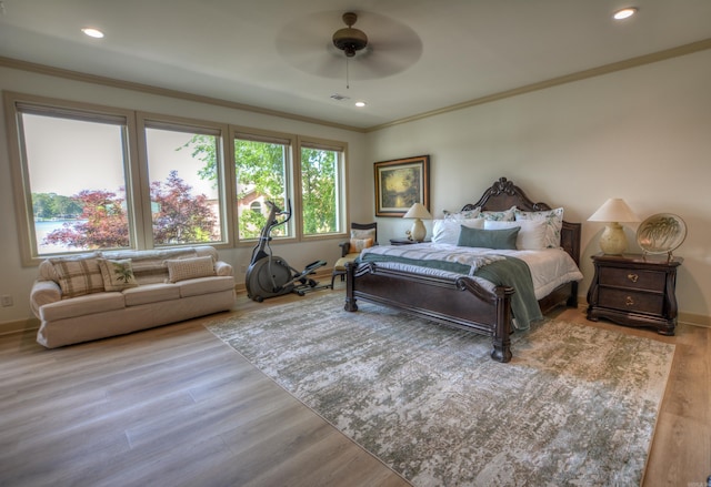 bedroom with crown molding, ceiling fan, and hardwood / wood-style floors