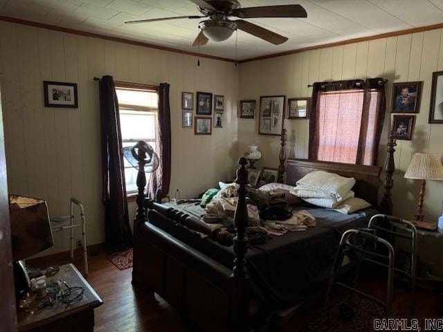 bedroom featuring crown molding, dark hardwood / wood-style flooring, and ceiling fan