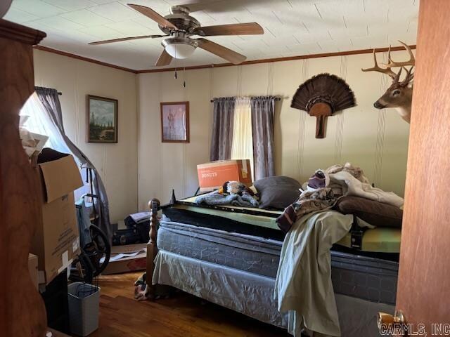 bedroom with ceiling fan and hardwood / wood-style flooring