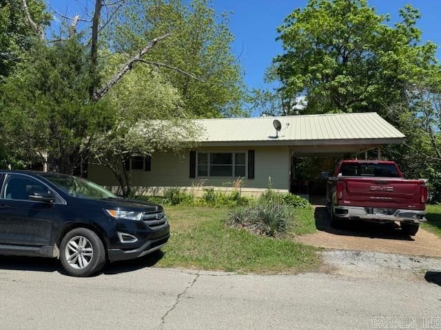 ranch-style house featuring a carport