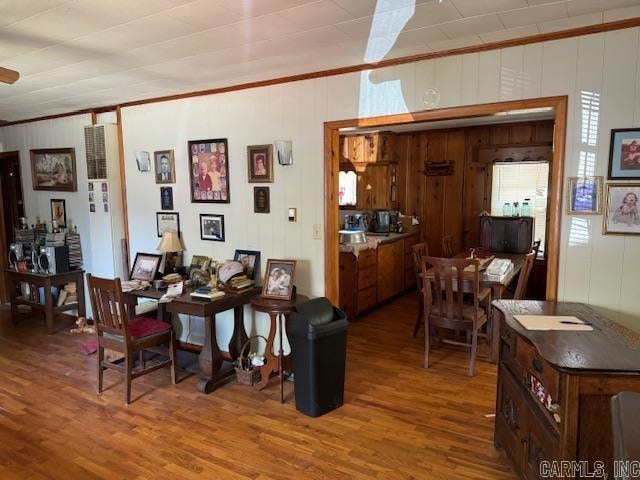 dining space with hardwood / wood-style floors and crown molding