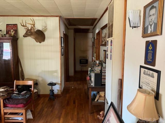 corridor with crown molding and hardwood / wood-style flooring