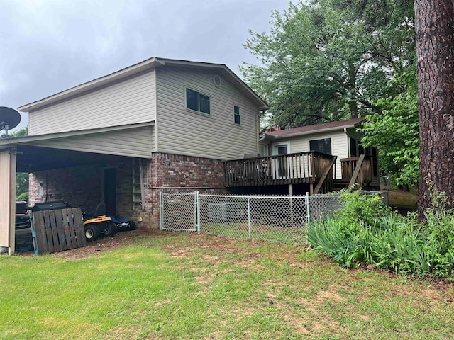 rear view of property with a deck and a lawn