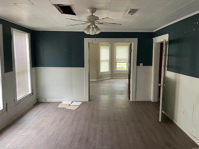 empty room with hardwood / wood-style floors, ceiling fan, and crown molding