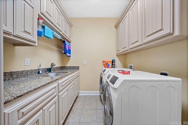 clothes washing area with light tile floors, cabinets, washer and clothes dryer, sink, and washer hookup