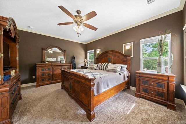 carpeted bedroom with ceiling fan and crown molding