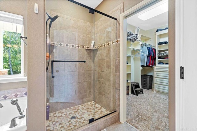 bathroom featuring a healthy amount of sunlight and shower with separate bathtub