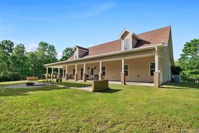 back of house featuring central AC unit and a lawn