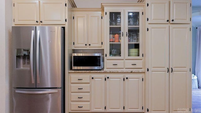 kitchen featuring light stone counters and stainless steel appliances