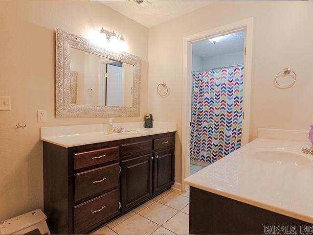 bathroom with vanity and tile flooring