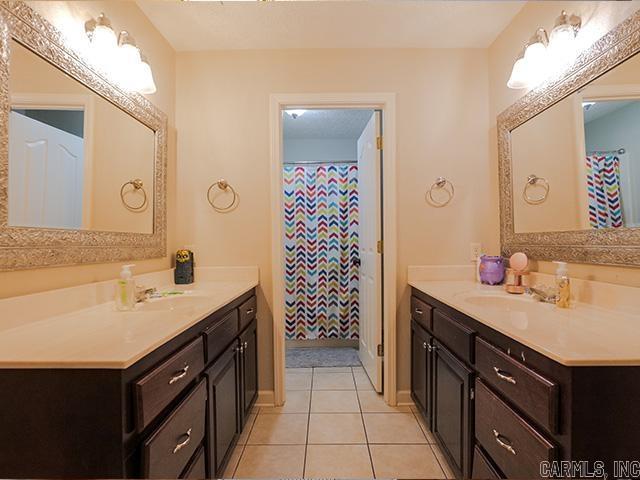 bathroom with tile floors and vanity