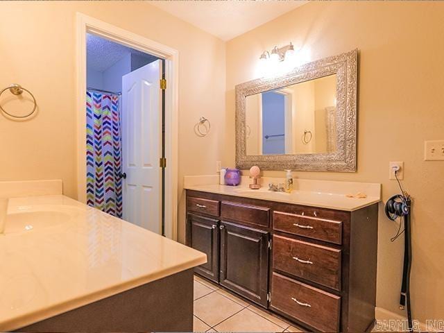 bathroom with vanity and tile flooring