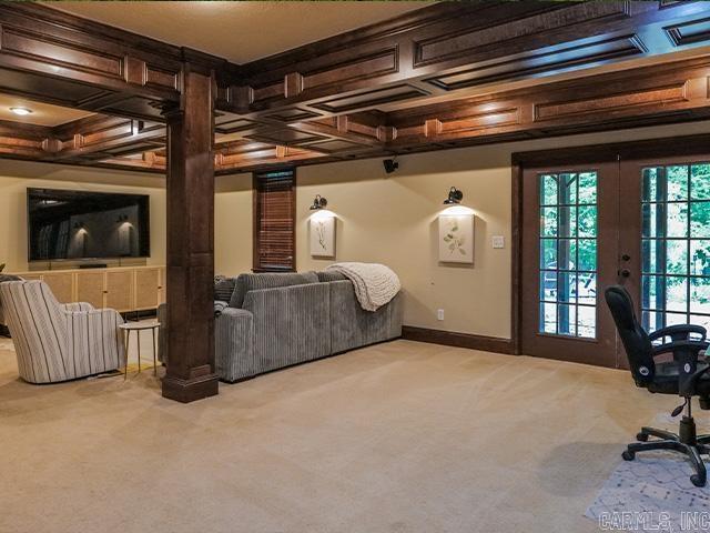 carpeted bedroom with french doors, access to outside, and coffered ceiling