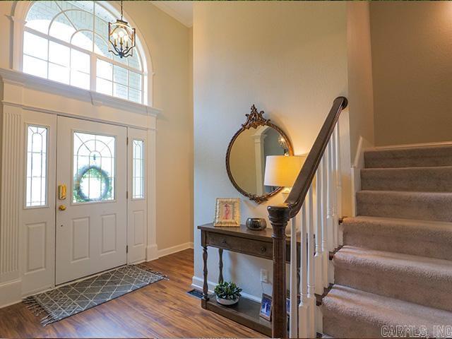 entryway featuring hardwood / wood-style floors and a high ceiling