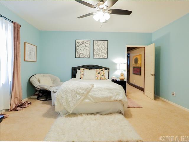 bedroom with ceiling fan and carpet floors