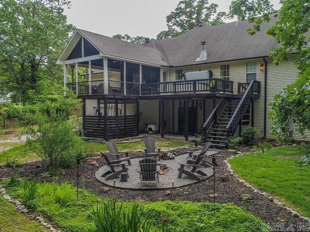 back of house featuring a patio area, a fire pit, and a wooden deck