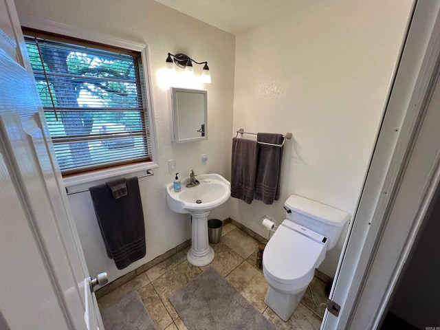 bathroom with tile floors and toilet