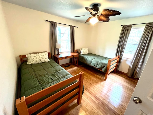 bedroom with wood-type flooring and ceiling fan