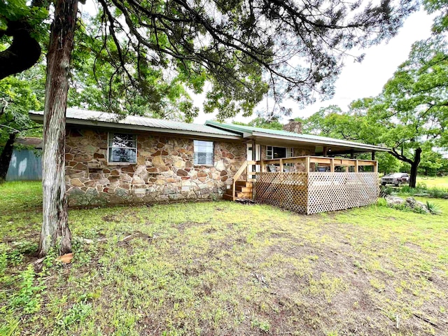 back of house with a yard and a deck